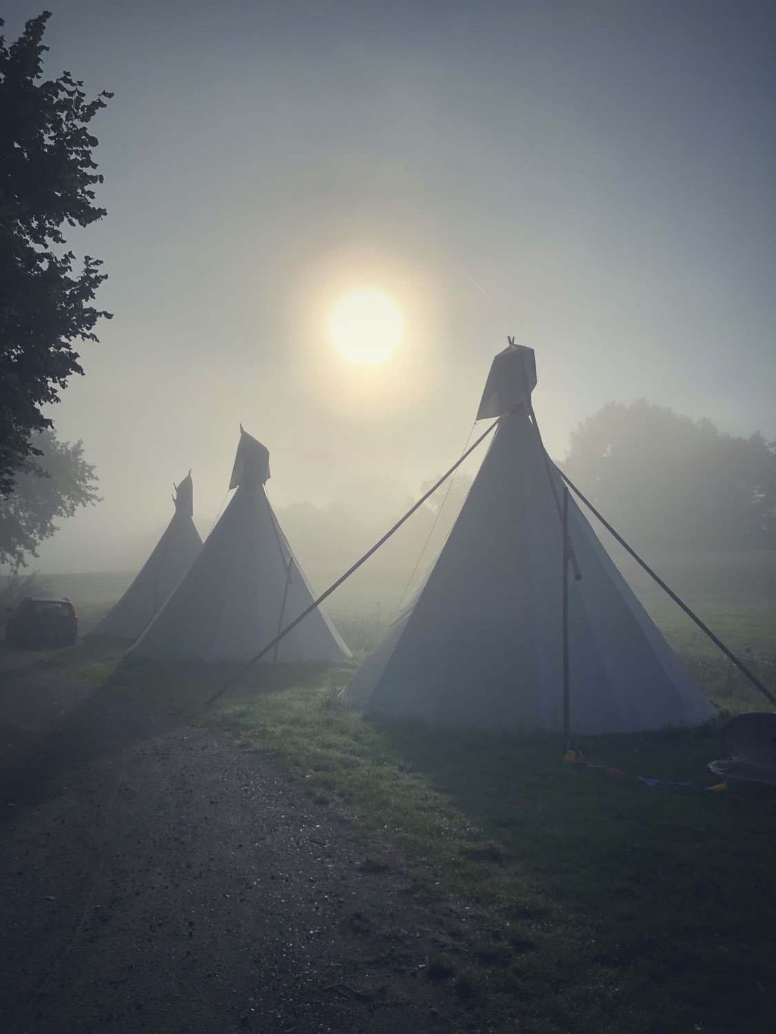 Tipi's in de mist bij zonsopkomst